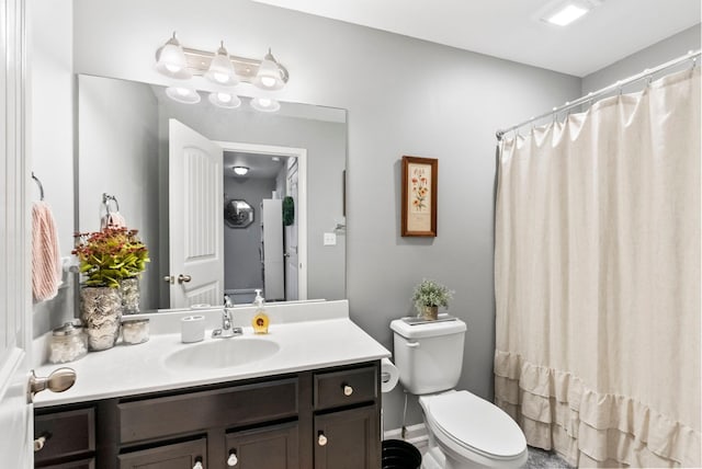 bathroom with toilet and vanity