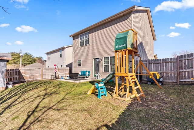 rear view of property featuring a fenced backyard, a patio area, a playground, and a yard