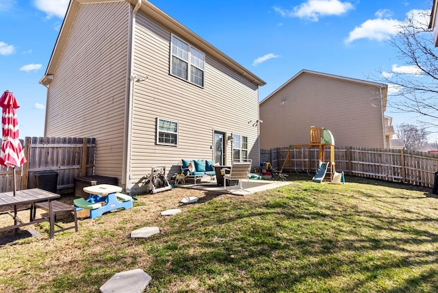 back of house featuring a lawn, a fenced backyard, and a patio area