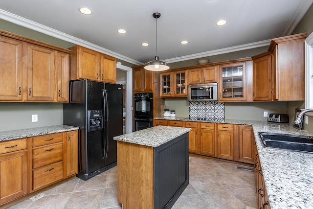 kitchen with brown cabinetry, a sink, black appliances, and crown molding