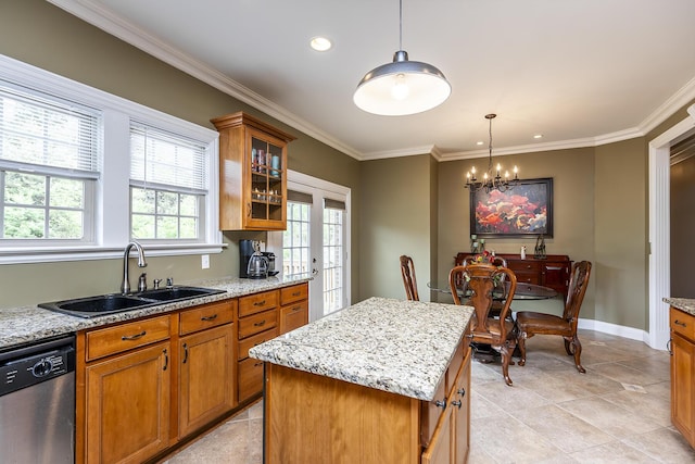 kitchen featuring dishwasher, brown cabinets, pendant lighting, and a sink