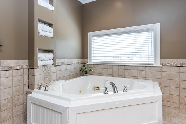 full bathroom with a whirlpool tub, tile walls, and a wainscoted wall