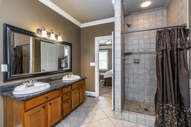 ensuite bathroom featuring a sink, double vanity, tiled shower, tile patterned flooring, and crown molding