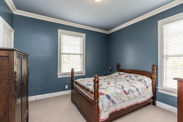 bedroom with baseboards, crown molding, and carpet flooring