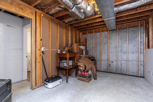 unfinished basement featuring washer / dryer