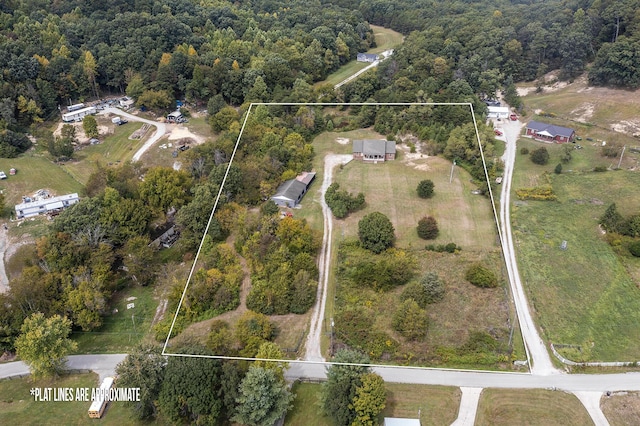 birds eye view of property with a wooded view
