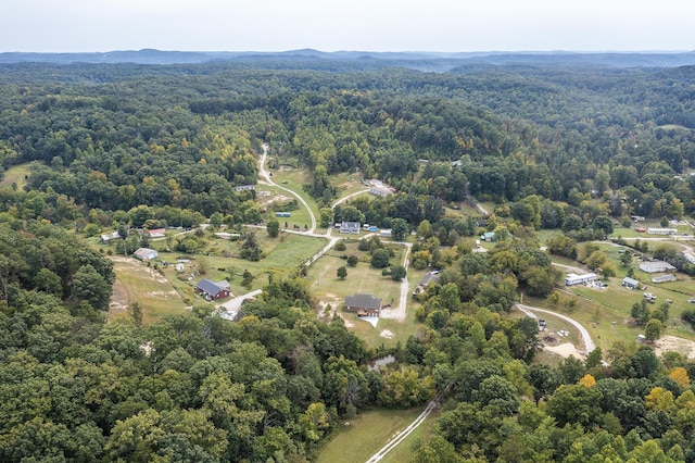 drone / aerial view featuring a wooded view