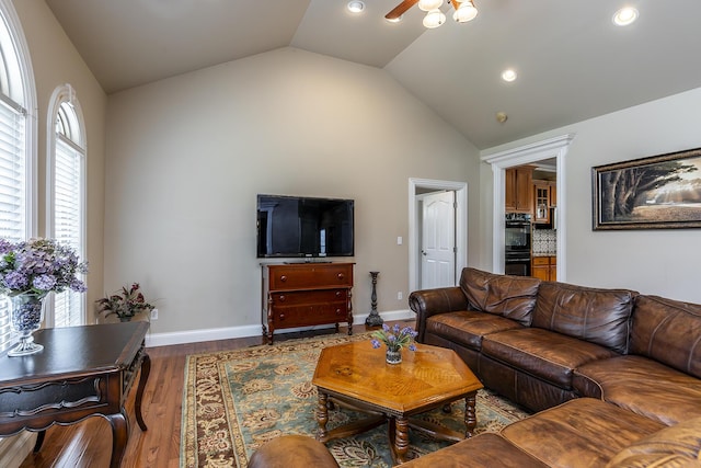 living area with recessed lighting, vaulted ceiling, a ceiling fan, and wood finished floors