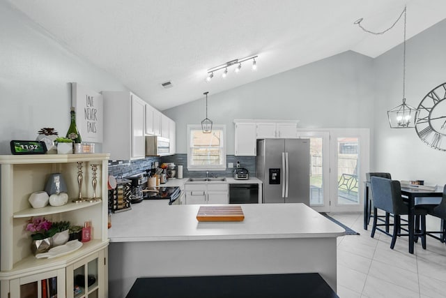 kitchen with white microwave, stainless steel fridge with ice dispenser, electric range oven, black dishwasher, and a sink