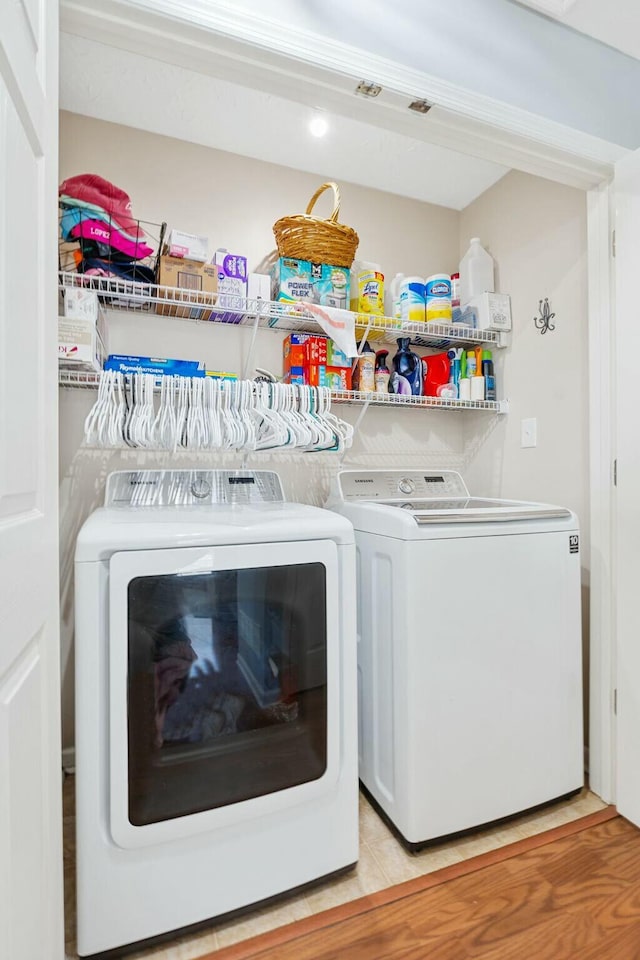 clothes washing area featuring laundry area and washing machine and clothes dryer