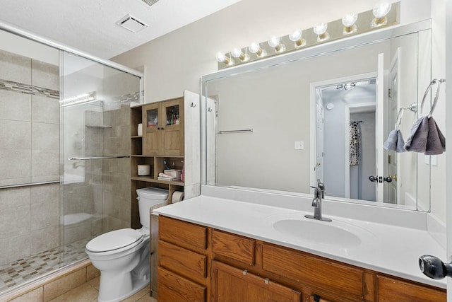 full bathroom featuring visible vents, a shower stall, toilet, and vanity