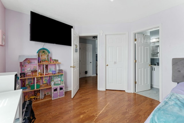 bedroom featuring light wood-style floors and baseboards