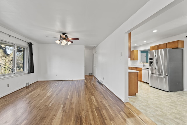 unfurnished living room with light wood-style floors, recessed lighting, baseboards, and visible vents