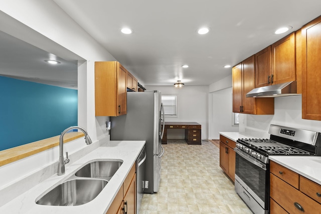 kitchen featuring under cabinet range hood, recessed lighting, appliances with stainless steel finishes, and a sink