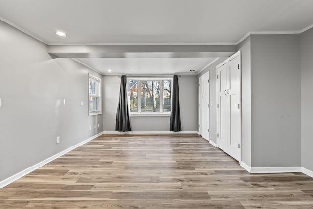 unfurnished room featuring light wood finished floors, recessed lighting, crown molding, and baseboards