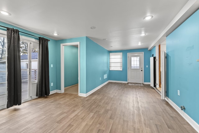 interior space featuring wood finished floors and baseboards