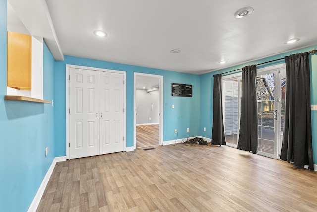 unfurnished bedroom with recessed lighting, a closet, baseboards, and light wood finished floors