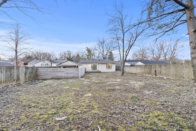 back of house featuring a fenced backyard