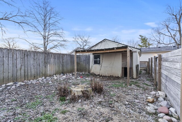 exterior space featuring an outbuilding and a fenced backyard