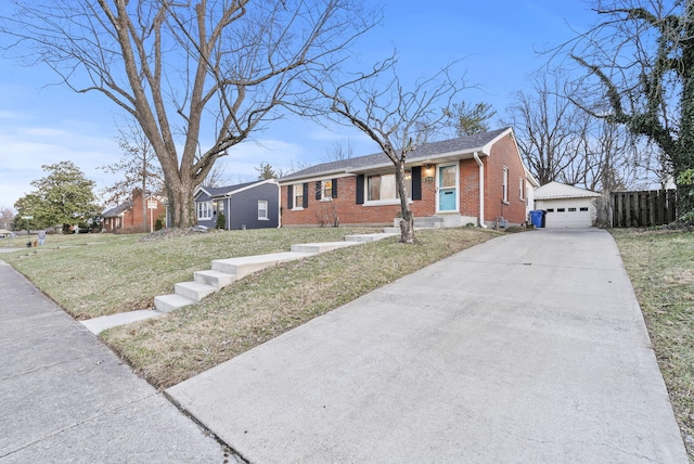 single story home featuring brick siding, a detached garage, fence, a front yard, and an outbuilding