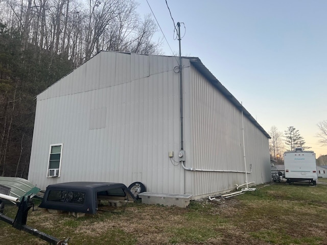 view of property exterior featuring cooling unit and a pole building