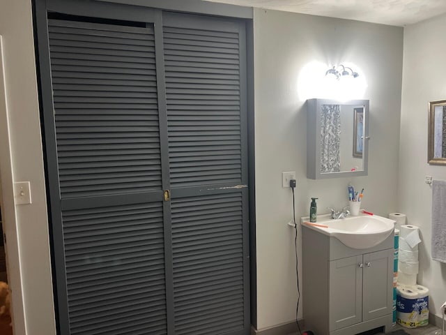 bathroom featuring vanity and a closet