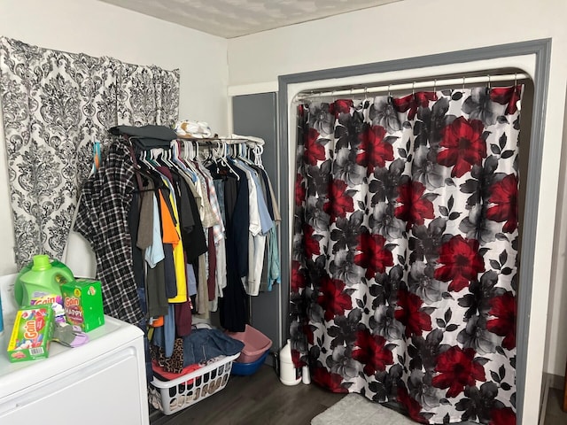 walk in closet featuring washer / dryer and wood finished floors