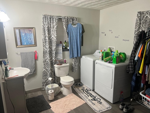 full bathroom with baseboards, toilet, wood finished floors, independent washer and dryer, and vanity