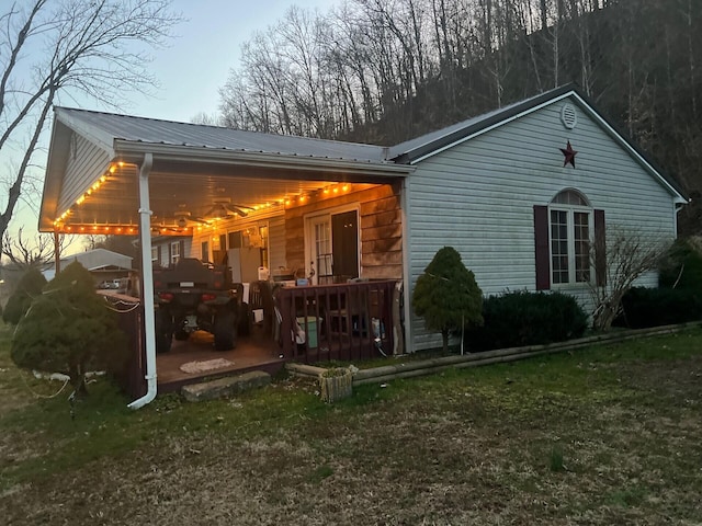 back of house featuring metal roof