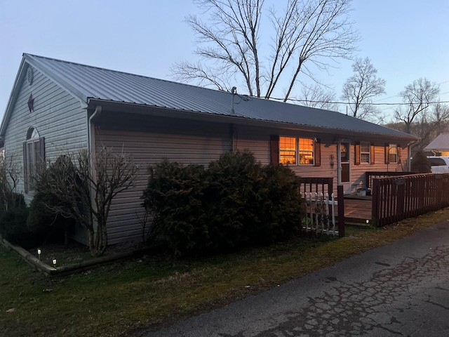 exterior space with a deck and metal roof