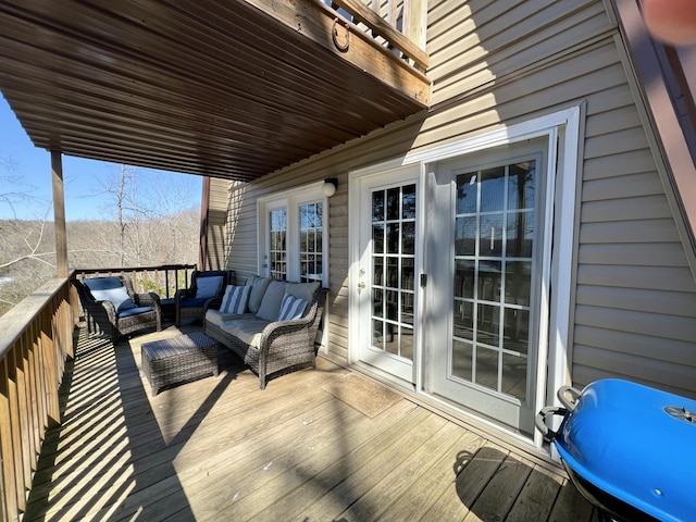 wooden deck with an outdoor living space