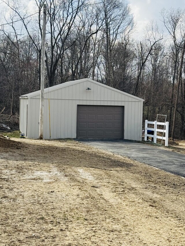 detached garage featuring fence