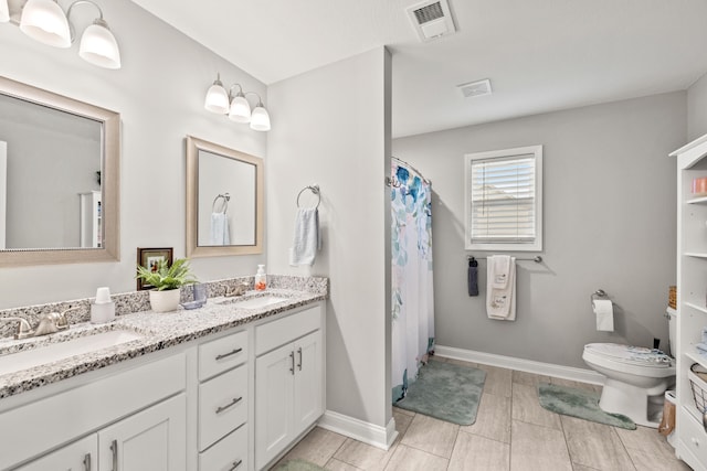 full bath featuring double vanity, visible vents, toilet, and a sink