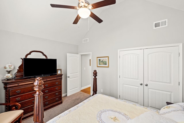 carpeted bedroom with visible vents, high vaulted ceiling, a closet, and a ceiling fan