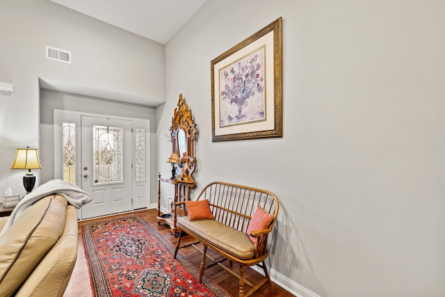 entryway featuring visible vents, wood finished floors, and baseboards