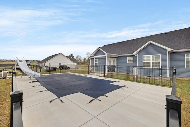 view of pool with a patio and fence