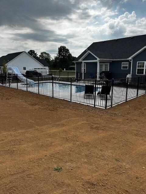 view of pool featuring a fenced in pool, fence, and a patio area