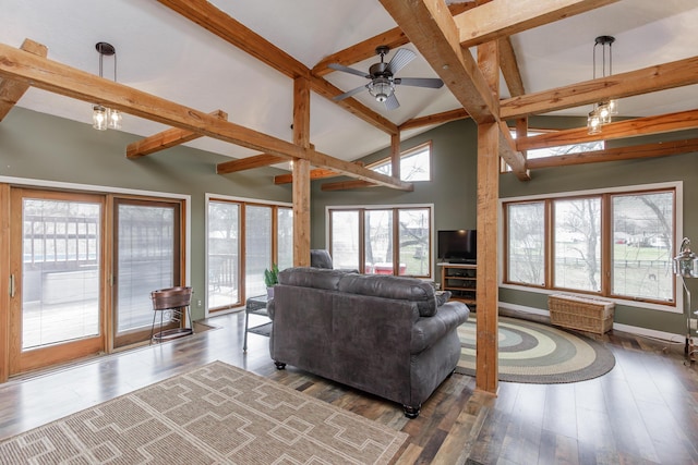 living area featuring wood finished floors, baseboards, high vaulted ceiling, beamed ceiling, and ceiling fan with notable chandelier