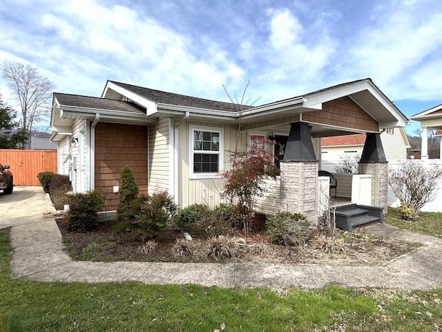 ranch-style home with fence