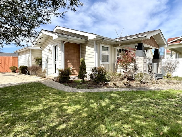 view of side of property with a lawn