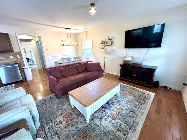 living area featuring hardwood / wood-style floors and baseboards