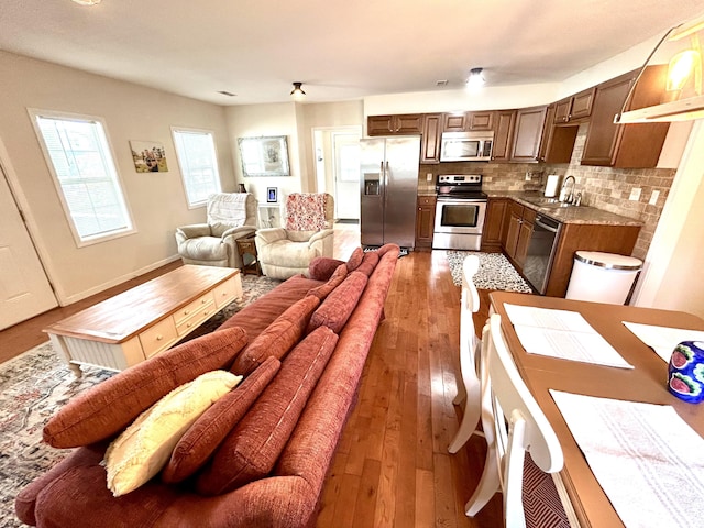 living room with light wood-type flooring and baseboards