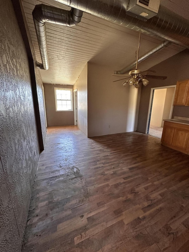 unfurnished living room featuring wood finished floors and ceiling fan