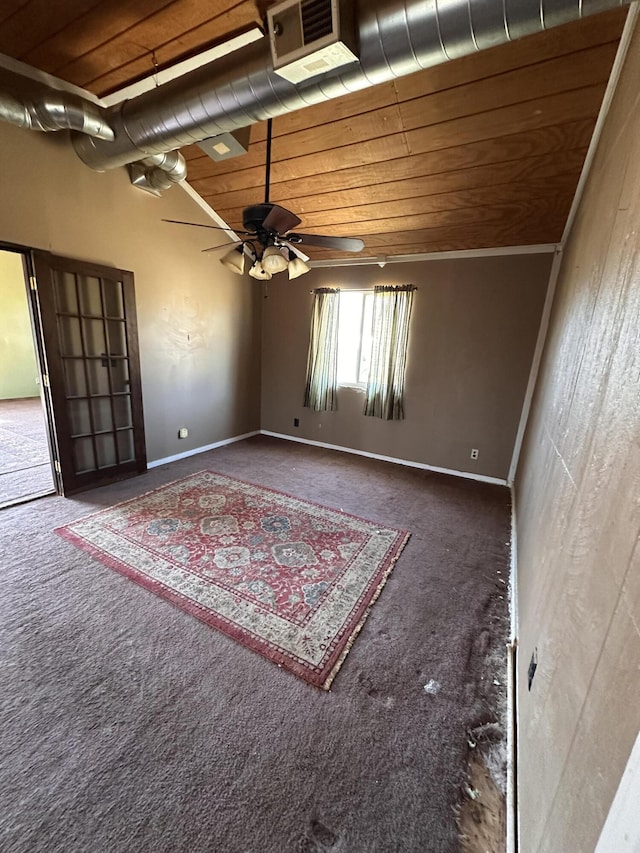 carpeted empty room featuring baseboards, a high ceiling, wooden ceiling, and a ceiling fan