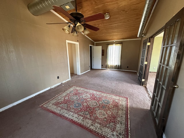 spare room with wooden ceiling, carpet, wood walls, and vaulted ceiling