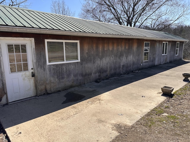 doorway to property featuring metal roof