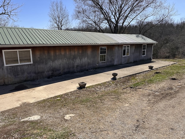 view of front facade featuring a patio area and metal roof