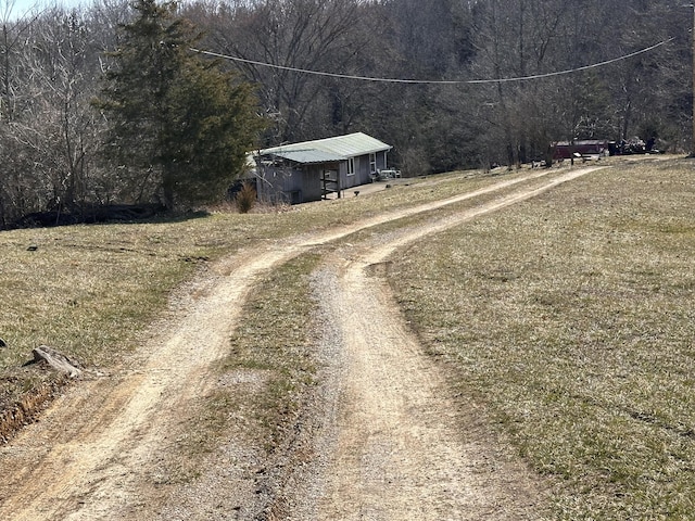 view of road with a forest view