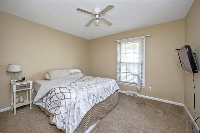 bedroom with visible vents, baseboards, carpet floors, and a ceiling fan