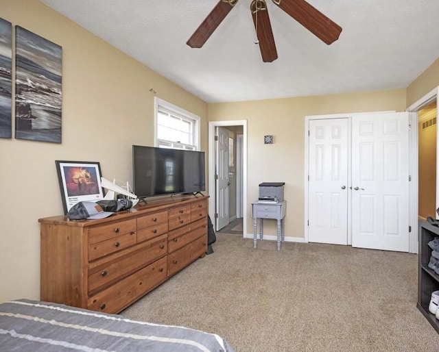 bedroom with a closet, a ceiling fan, baseboards, and carpet floors